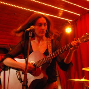 Woman playing accoustic guitar